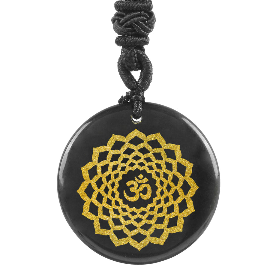 Black round stone pendant with gold lotus and Om symbol on a black cord