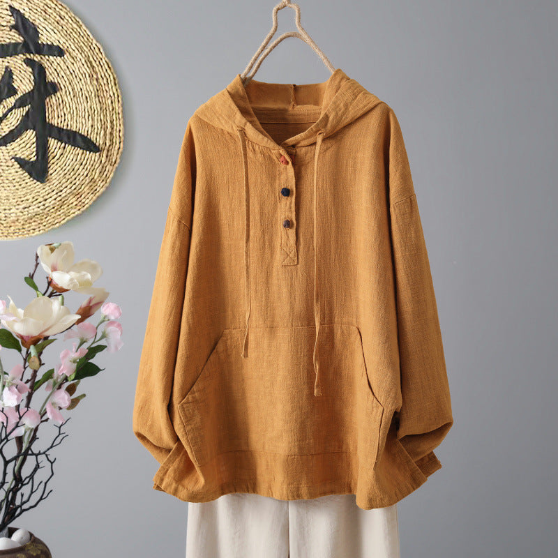 Front view of a tan cotton women's hoodie hanging on a wooden hanger