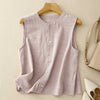Pink sleeveless button-up shirt on a wooden hanger