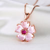 Close up of pink crystal flower pendant on chain