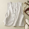 Light colored sleeveless button-up vest with V-neck laid flat