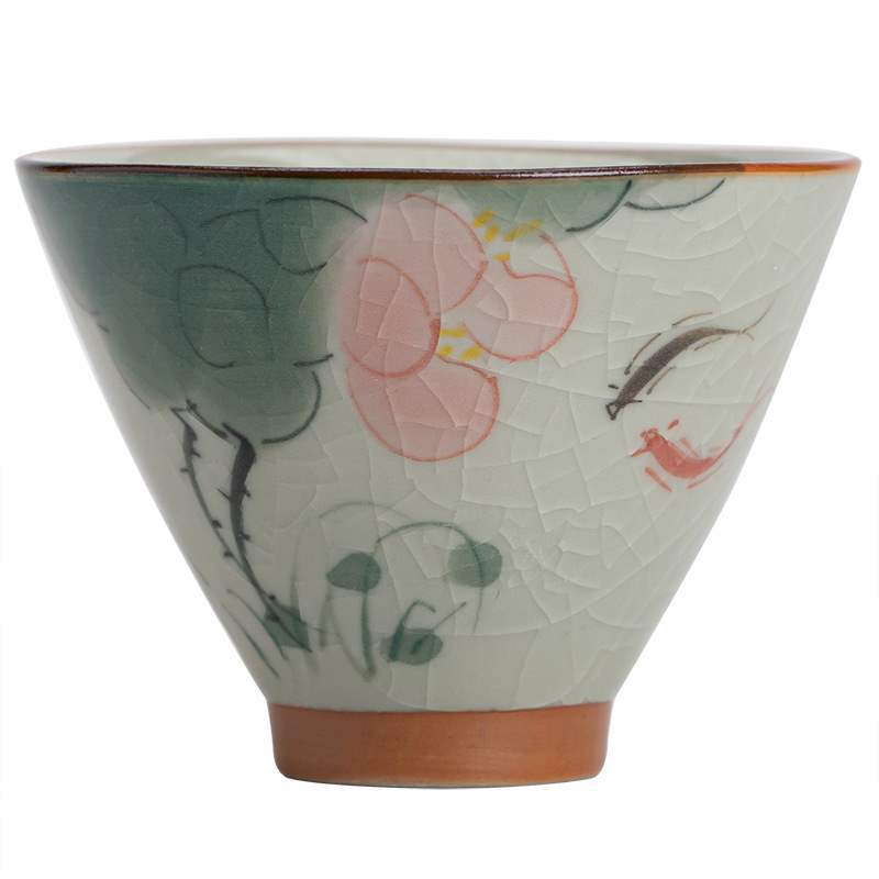Close-up of a hand-painted ceramic teacup featuring a pink lotus flower and a koi fish on a crackled white background.