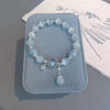 Blue cat's eye bead bracelet with silver star charm on blue box
