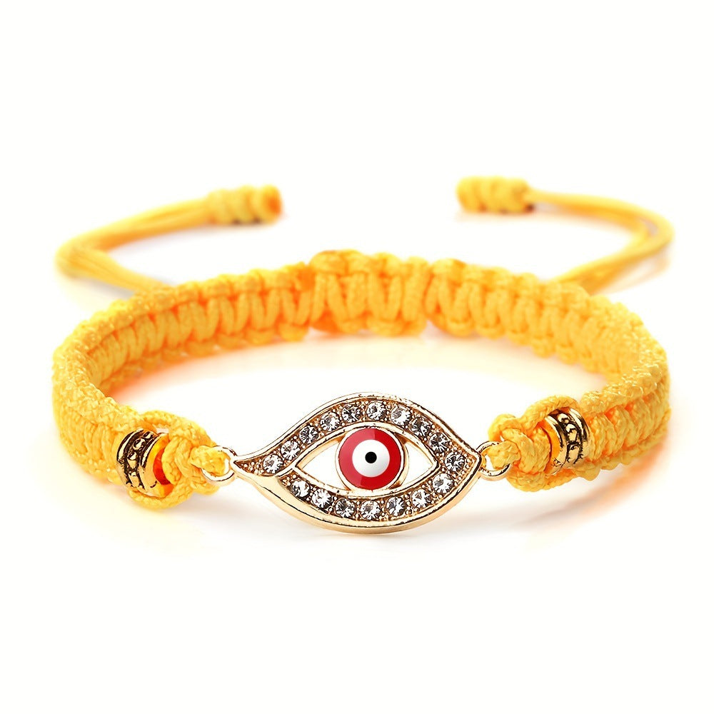 Yellow hand-woven bracelet with gold-tone Evil Eye charm