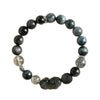 A single strand bracelet featuring dark grey beads and a carved Pixiu figure.