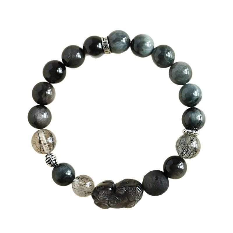 A single strand bracelet featuring dark grey beads and a carved Pixiu figure.