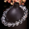 Close up of a clear crystal beaded bracelet on a dark stand