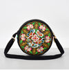 Round black canvas crossbody bag with colorful floral embroidery