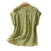 Back view of a green sleeveless cotton linen shirt with yellow flowers