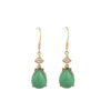 Pair of gold-tone hook earrings with green teardrop agate stones on a wooden surface