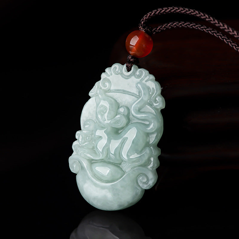 Close-up of a pale green carved jade pendant depicting a Chinese zodiac animal on a dark cord.