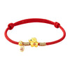 Red string bracelet with gold sheep charm and silver beads on white background