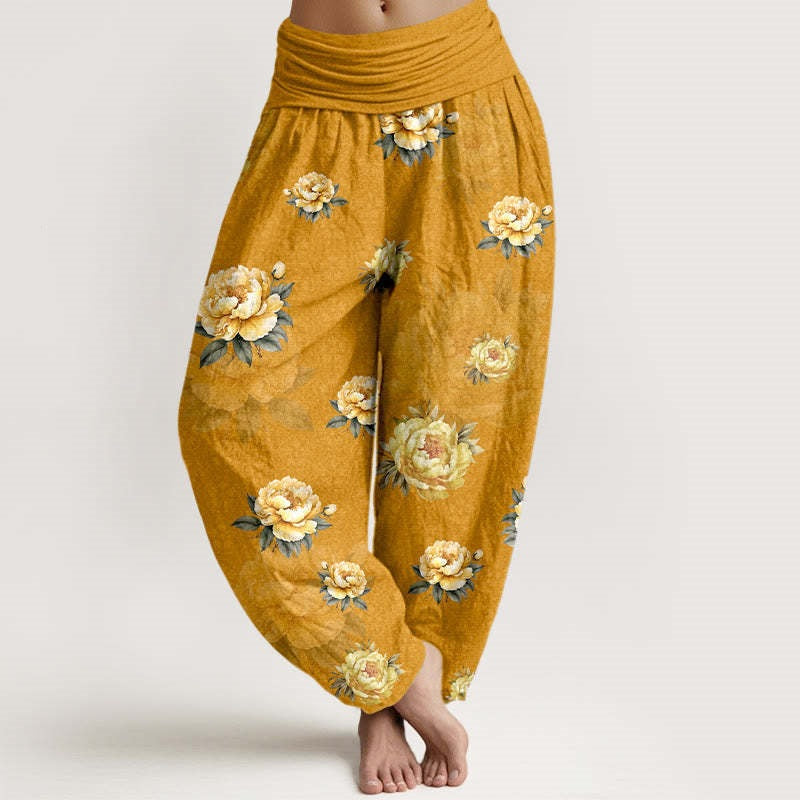 Model wearing mustard yellow harem pants with a yellow rose pattern