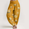 Model wearing mustard yellow harem pants with a yellow rose pattern