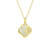 Close up of a silver four-leaf clover pendant with bamboo details and white jade on a chain.
