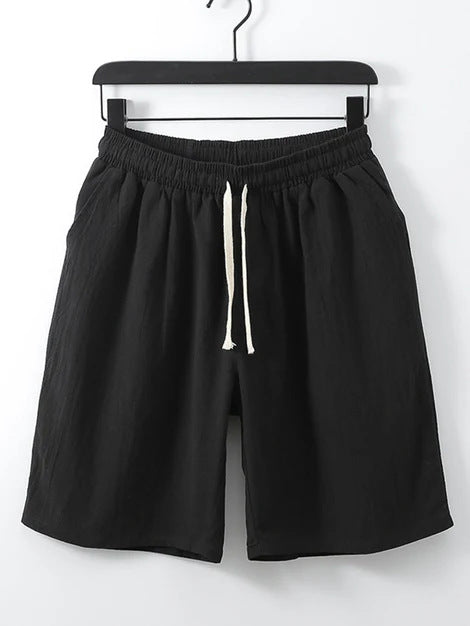 Black men's casual shorts hanging on a hanger