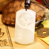 White jade pendant with Pixiu and Yin Yang carving on a dark cord