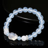 Blue chalcedony beaded bracelet with a white agate rabbit charm on a black background