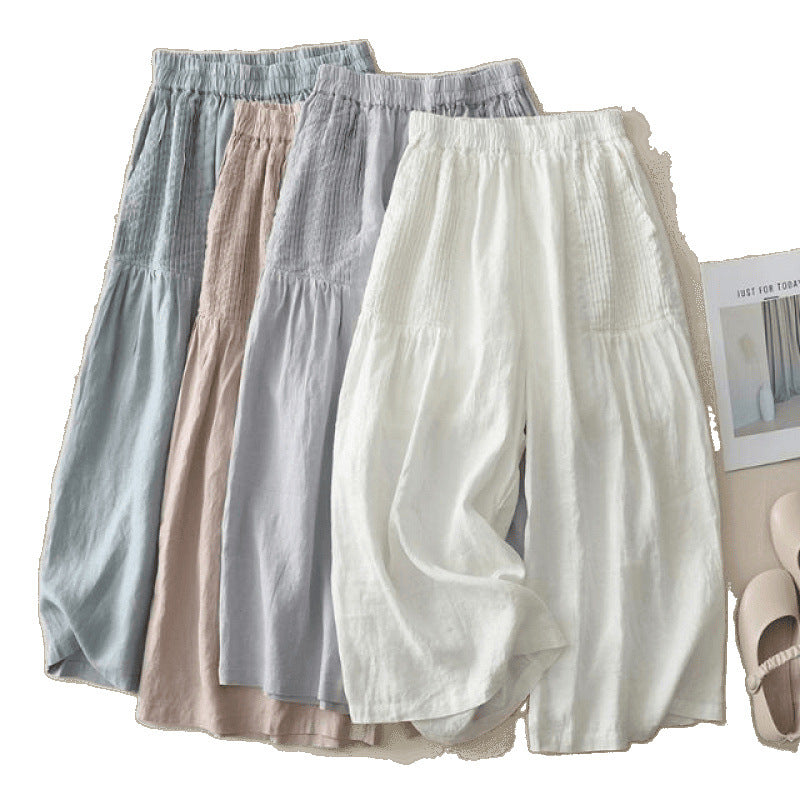 Light grey wide leg cotton linen pants with pleated waist detail laid flat