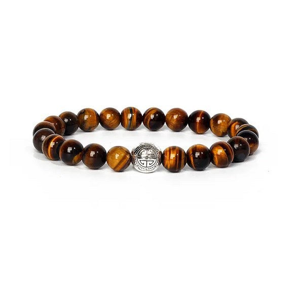 A stretch bracelet made of brown tiger eye beads with a silver crown charm in the center
