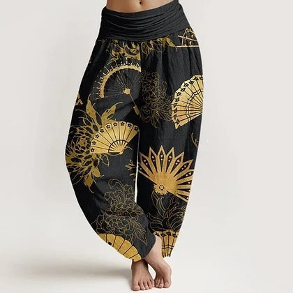 A woman wearing black harem pants with a gold fan pattern
