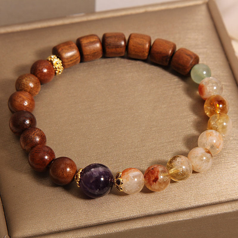 Close up of a mixed wood and crystal beaded bracelet on a beige tray