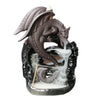 Close up of a black ceramic dragon incense burner with white smoke flowing down like water