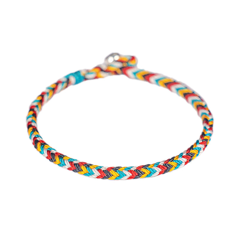 Close up of the colorful braided cord and metal clasp on a red background