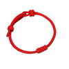 Close up of a red braided cord bracelet with a knot closure