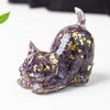 Resin cat figurine filled with purple amethyst crystal gravel and gold foil flakes