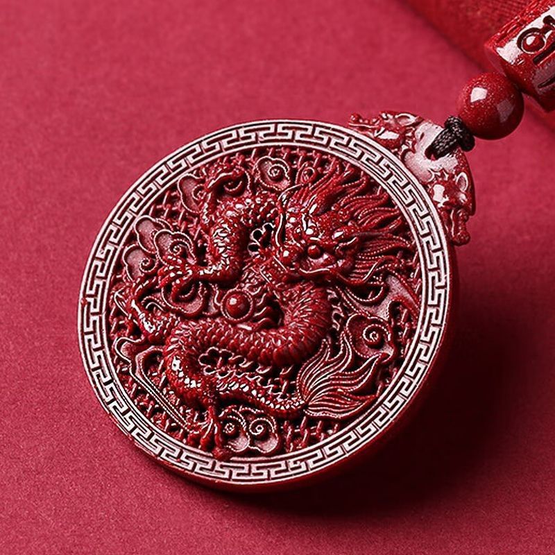 Red carved cinnabar pendant necklace featuring a detailed dragon design on a black cord