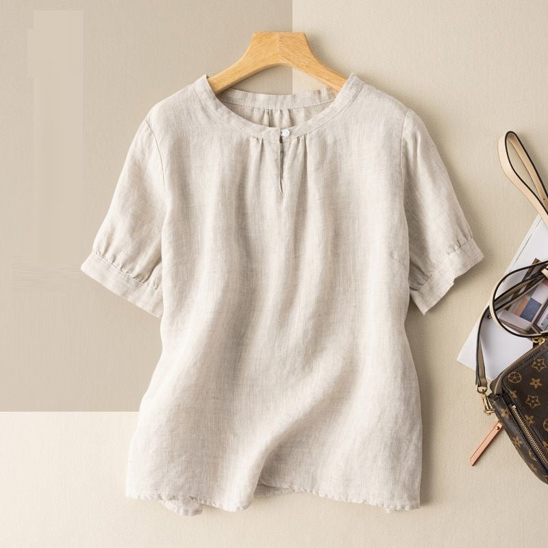 Beige women's casual half sleeve shirt with round neck hanging on a wooden hanger