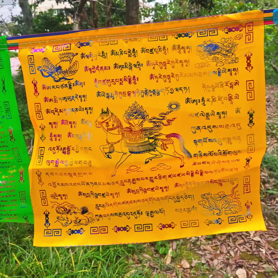 Yellow Tibetan prayer flag with Windhorse and mantras hanging outdoors