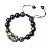 Close up of black obsidian beaded bracelet with gold pixiu charm on wrist
