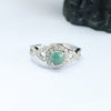 Close-up view of a blue water jade ring with a geometric band