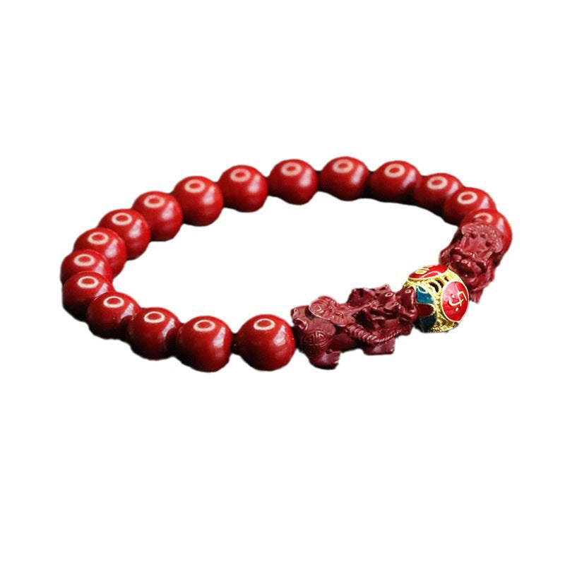 Red cinnabar beaded bracelet with two carved pixiu figures and a colorful center bead