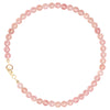 Close up of a 3mm pink crystal bracelet with a gold clasp on a white background