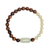 Close-up of a brown wood and pale jade beaded bracelet on a linen background