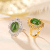Two adjustable rings with green oval stones and intricate metalwork side by side