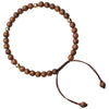 Close-up of a brown wooden bead bracelet with gold accents on a wrist