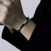 Nine-Eye Dzi Bead Pattern Bracelet, Black Cord with White Copper Charm