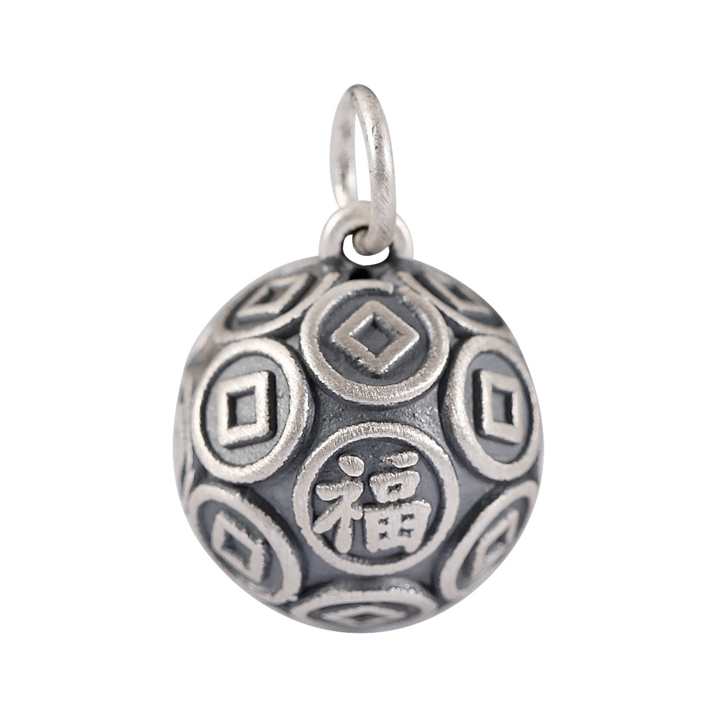 Close up of a round 999 silver bead with coin patterns and a Fu character on a leather background