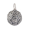 Close up of a round 999 silver bead with coin patterns and a Fu character on a leather background