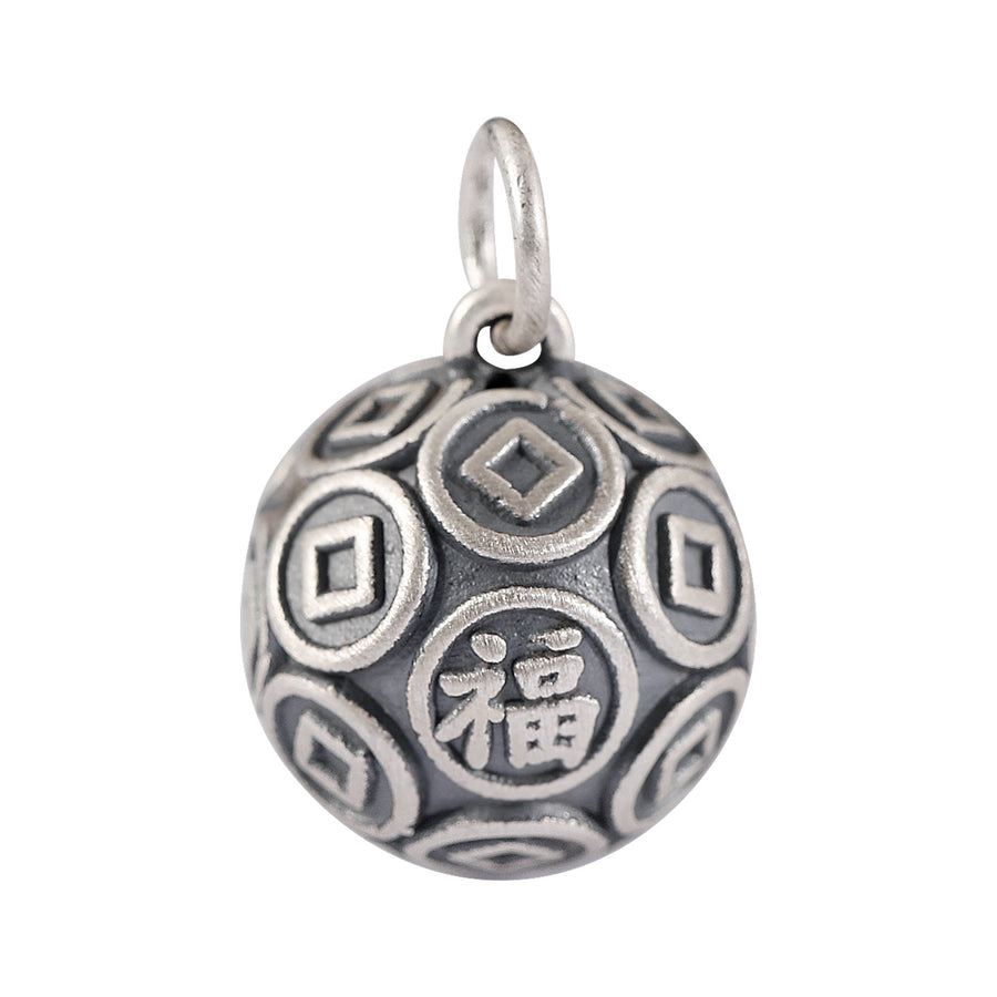 Close up of a round 999 silver bead with coin patterns and a Fu character on a leather background