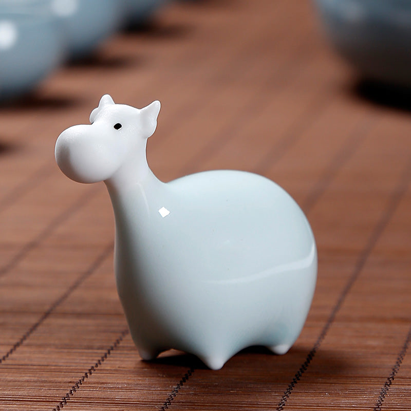 Small ceramic tea pet figurine in light blue glaze shaped like an animal