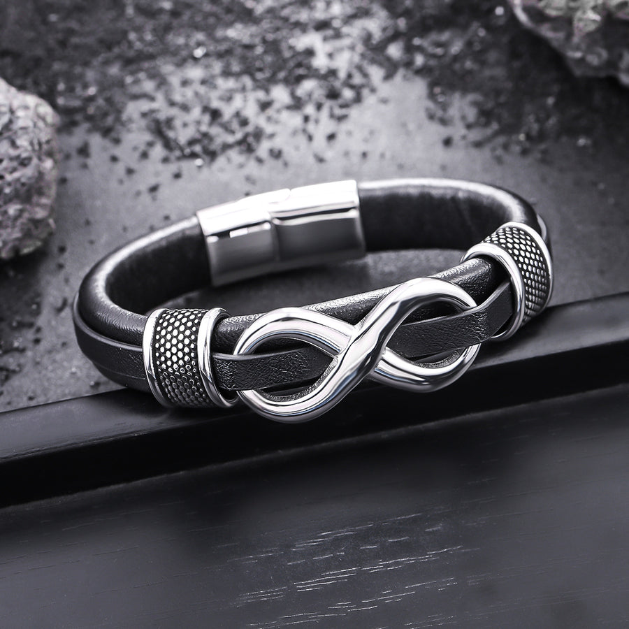 Close up of black leather bracelet with silver infinity symbol and steel clasp