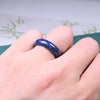 Close up view of a polished blue lapis lazuli ring on a green surface