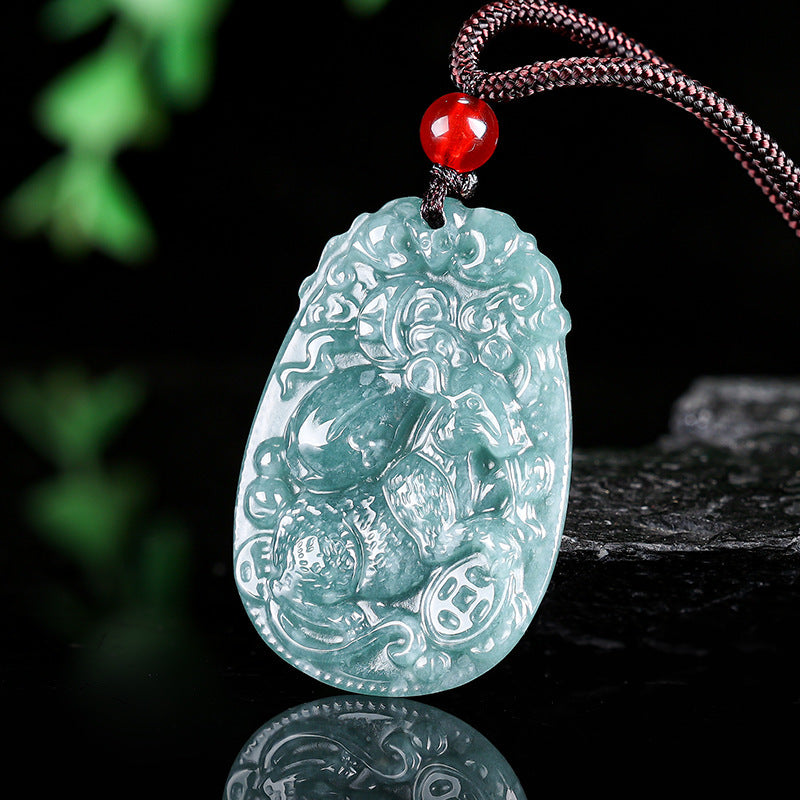 Carved blue water jade pendant with red bead on dark cord