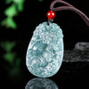 Carved blue water jade pendant with red bead on dark cord