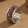 Close up of blue enamel koi fish ring with heart sutra engraving inside